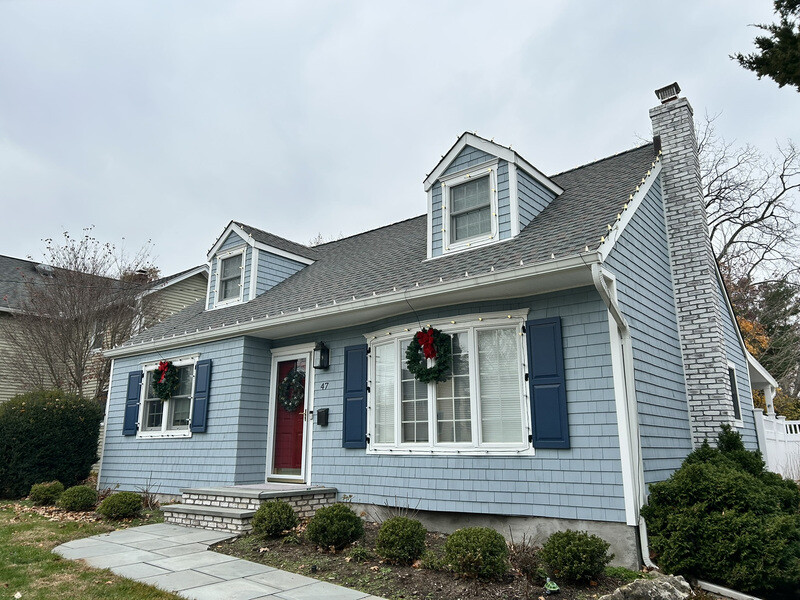 Suburban home in daylight before permanent lighting